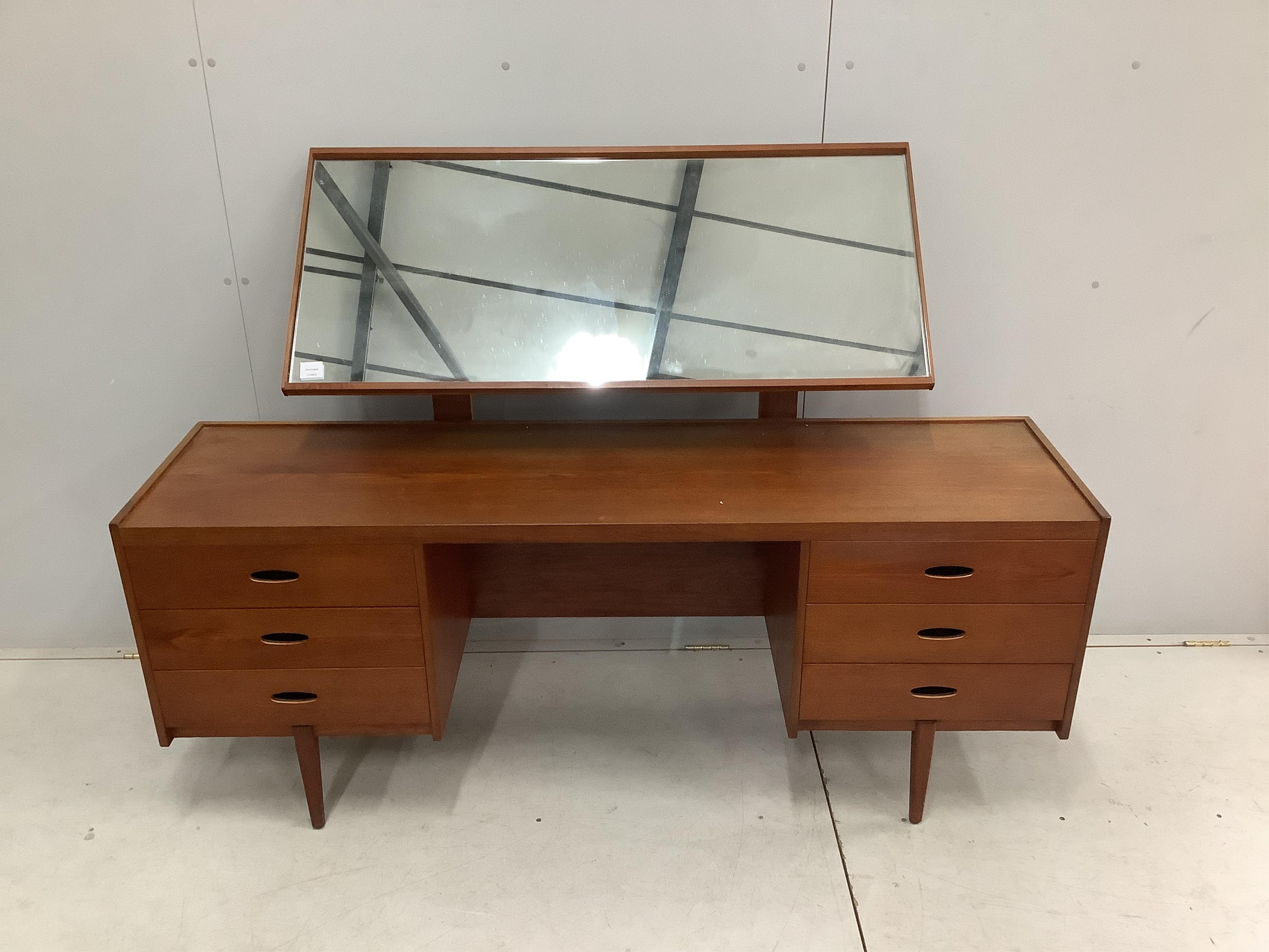 An Austin Suite teak dressing table, width 168cm, depth 44cm, height 126cm